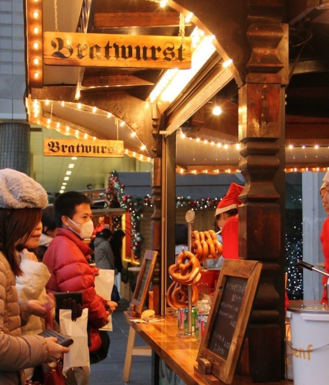 Festive goers queuing for pretzels at the German Christmas Market in Osaka, Japan